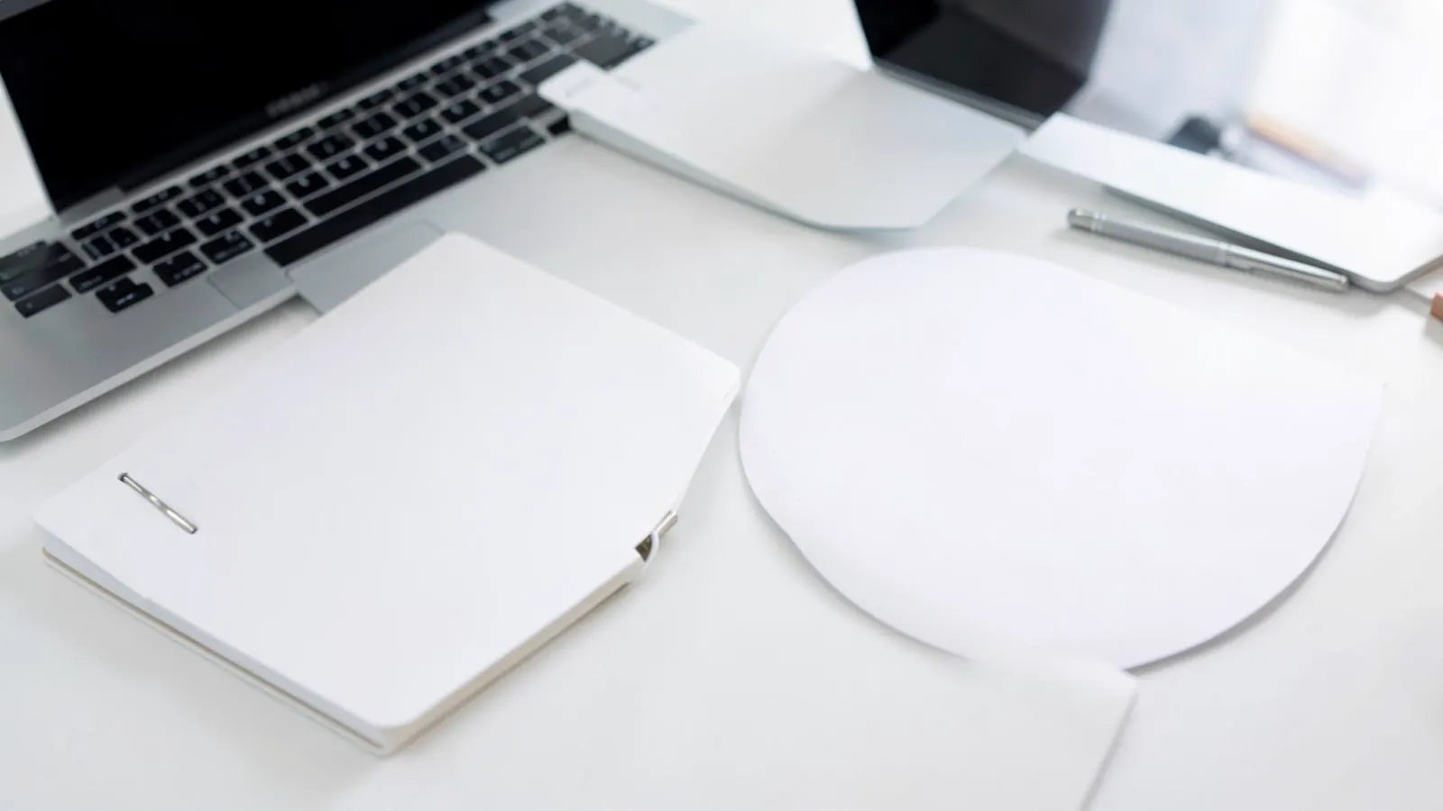 Blank operations manual and notebook on a bright office desk